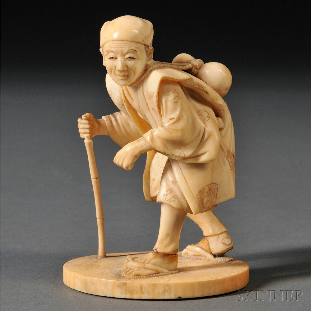 Ivory Okimono of a Man with a Cane, Japan, 18th/19: Ivory Okimono of a Man with a Cane, Japan, 18th/19th century, hunchbacked old man with a gourd on his back, standing on an oval ivory base, wearing sandals, delicately carved with detailed facial feat