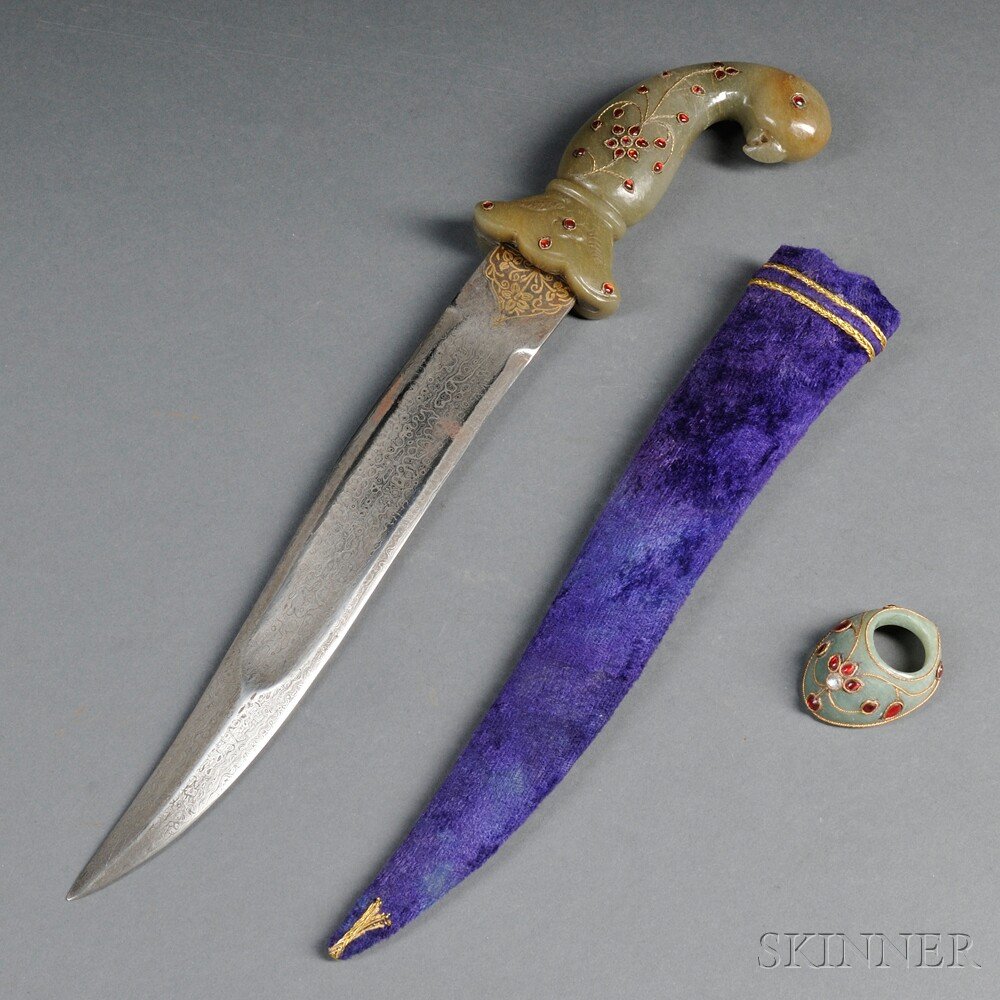 Mughal Dagger, India, 20th century, the curved ta: Mughal Dagger, India, 20th century, the curved tapering double-edged watered steel blade with gilt floral decorations, the jade hilt in the form of a bird inset with red glass and gilt metal, with a p