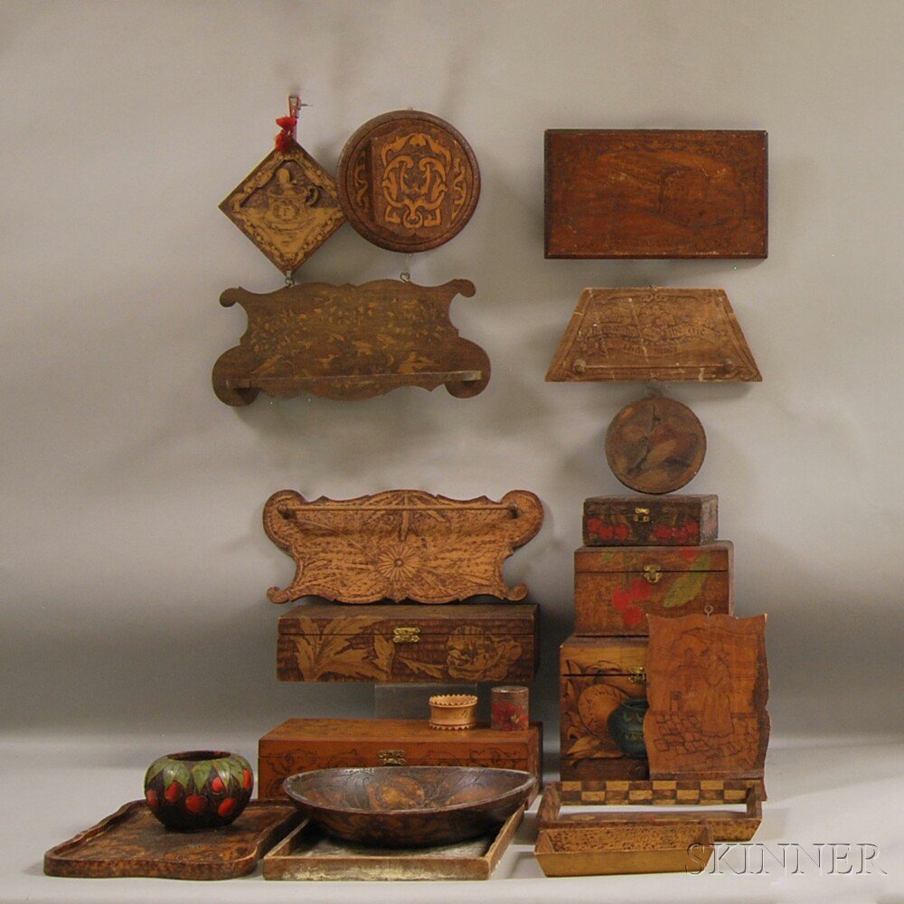 Twenty-one Pyrographic Kitchen and Decorative Items, fi: Twenty-one Pyrographic Kitchen and Decorative Items, five boxes, four trays, two bowls, four towel racks, two plaques, a wall pocket, two napkin rings, and a trivet, some by Flemish Art.