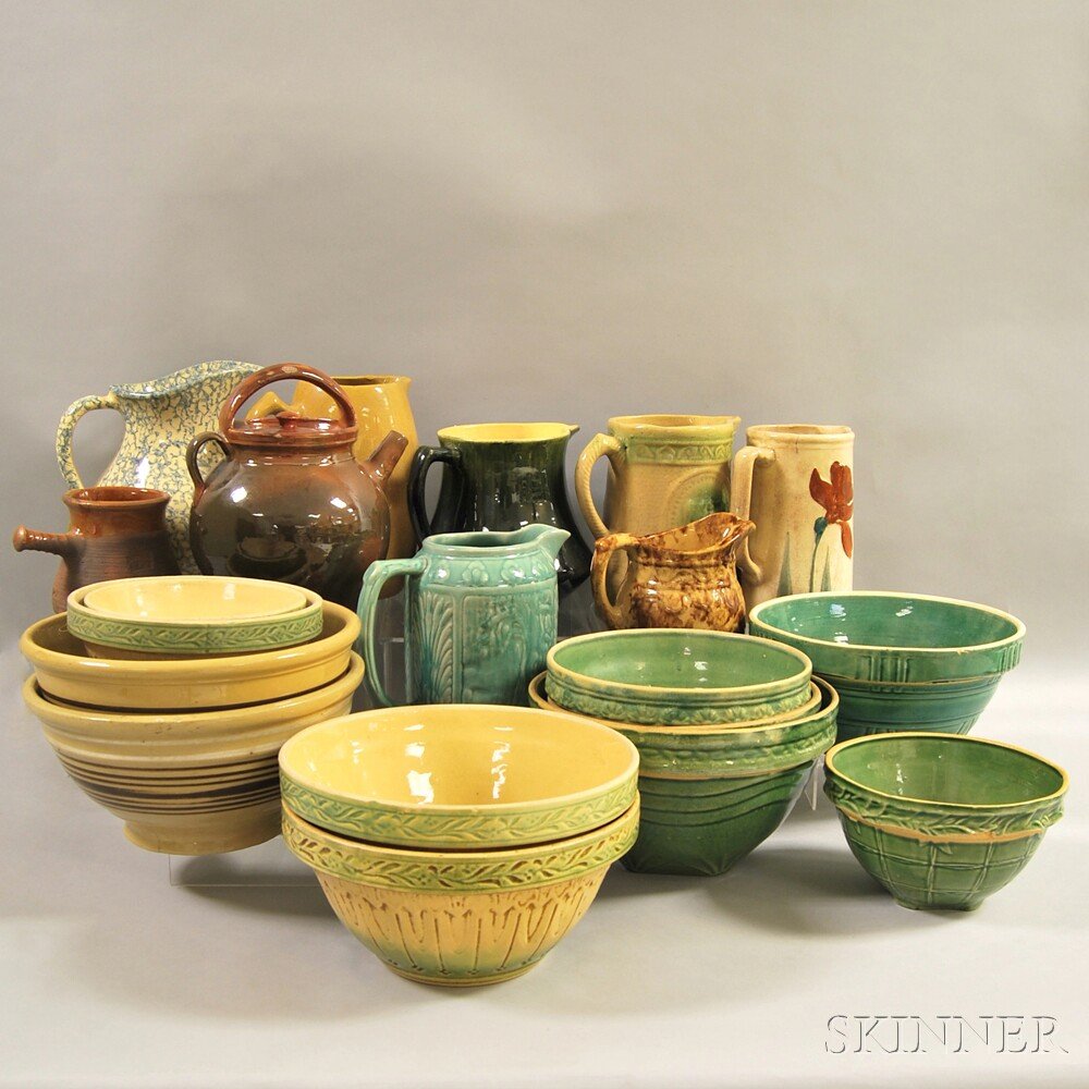 Seven Glazed and Sponge-decorated Pottery Pitchers, Ele: Seven Glazed and Sponge-decorated Pottery Pitchers, Eleven Glazed and Banded Yellowware Kitchen Bowls, a Glazed Ovoid Redware Jug with Cover, and a Small Glazed Redware Jug with Handle.