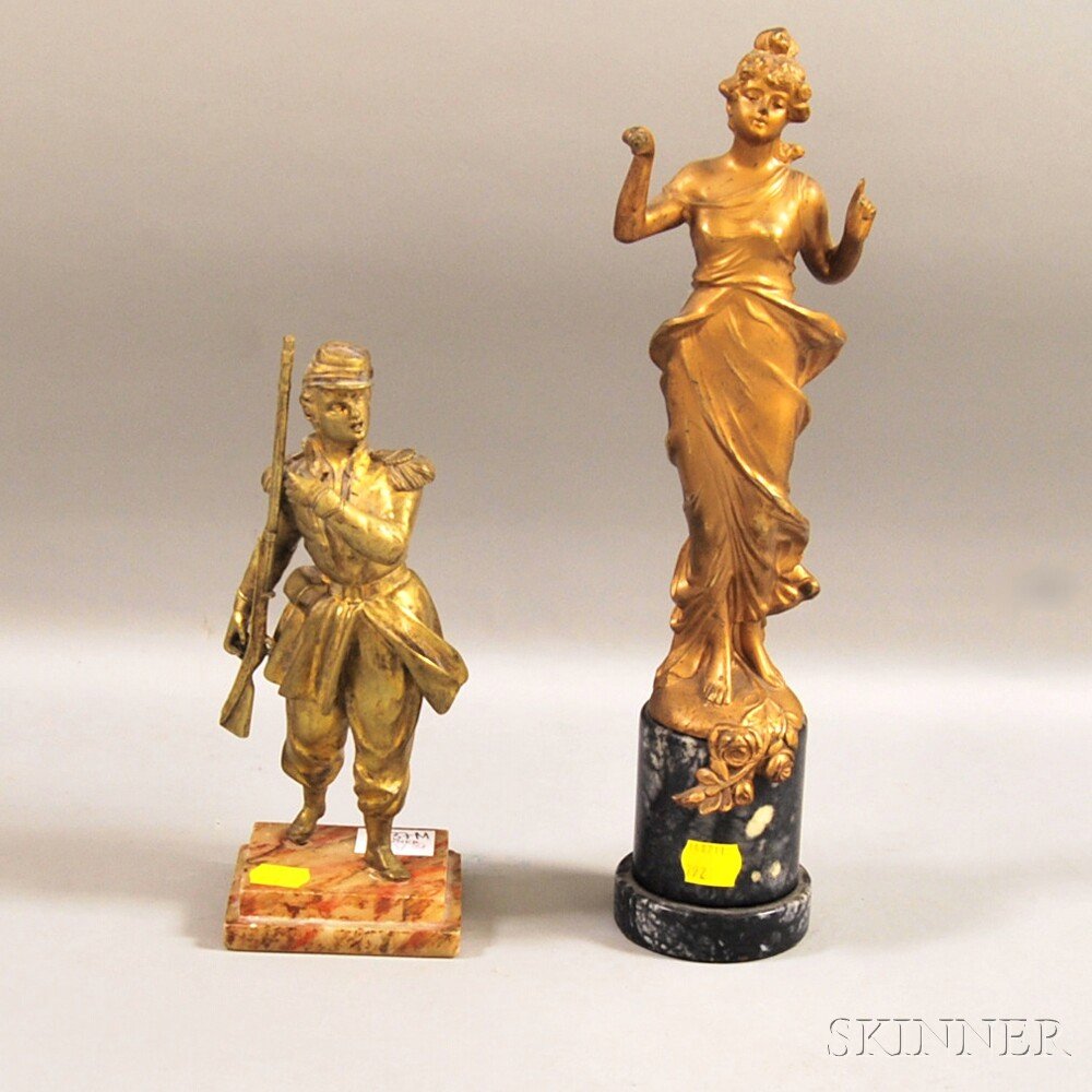 Gilt-metal Figure of a Maiden and a Gilt-bronze Figure: Gilt-metal Figure of a Maiden and a Gilt-bronze Figure of a Soldier, the maiden on a marble base, the soldier on a painted alabaster base, ht. 13 and 8 5/8 in., respectively.
