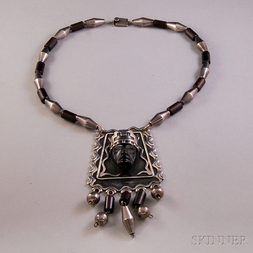 Mexican Sterling Silver and Wood Necklace, Taxco, the n: Mexican Sterling Silver and Wood Necklace, Taxco, the necklace composed of alternating silver and wood beads, the pendant with a carved stone head and tassels of wood and silver beads, stamped "STERLI