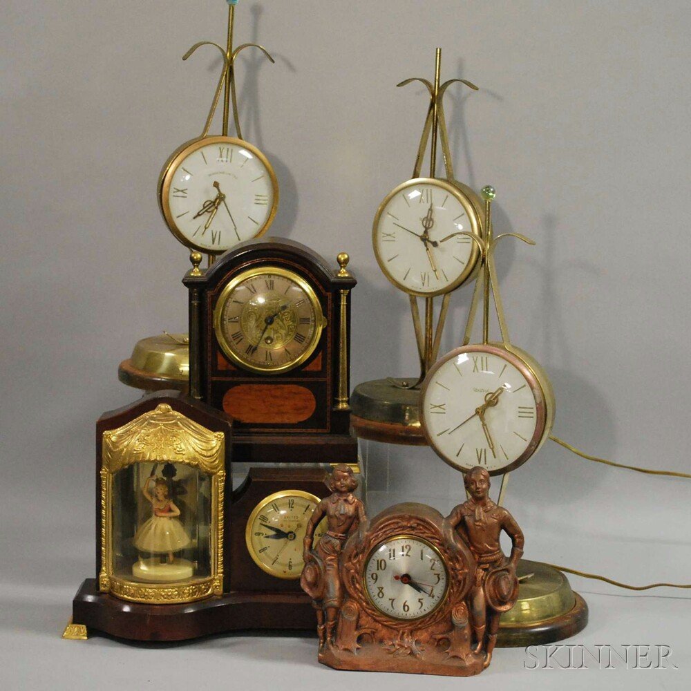 Six Electric Clocks, three Sessions United mantel clock: Six Electric Clocks, three Sessions United mantel clocks, with 5-in. Roman numeral dials, brass-finish cases, all sitting on turned wood bases; a United figural clock with turning ballerina on platfor
