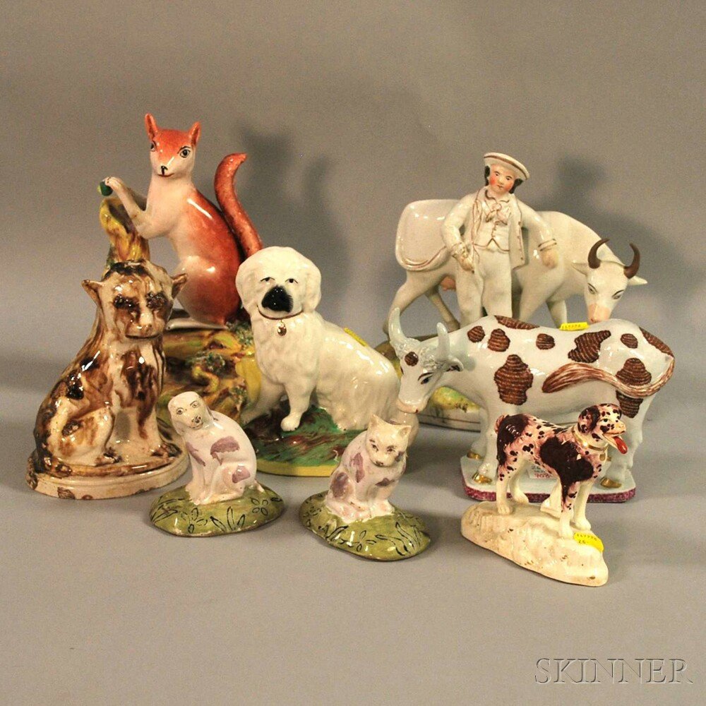 Eight Assorted Staffordshire and Faience Ceramic Figure: Eight Assorted Staffordshire and Faience Ceramic Figures and Figural Groups, a seated dog and spaniel, standing spaniel, a boy with a cow, a squirrel, and a standing cow, and a pair of faience seated