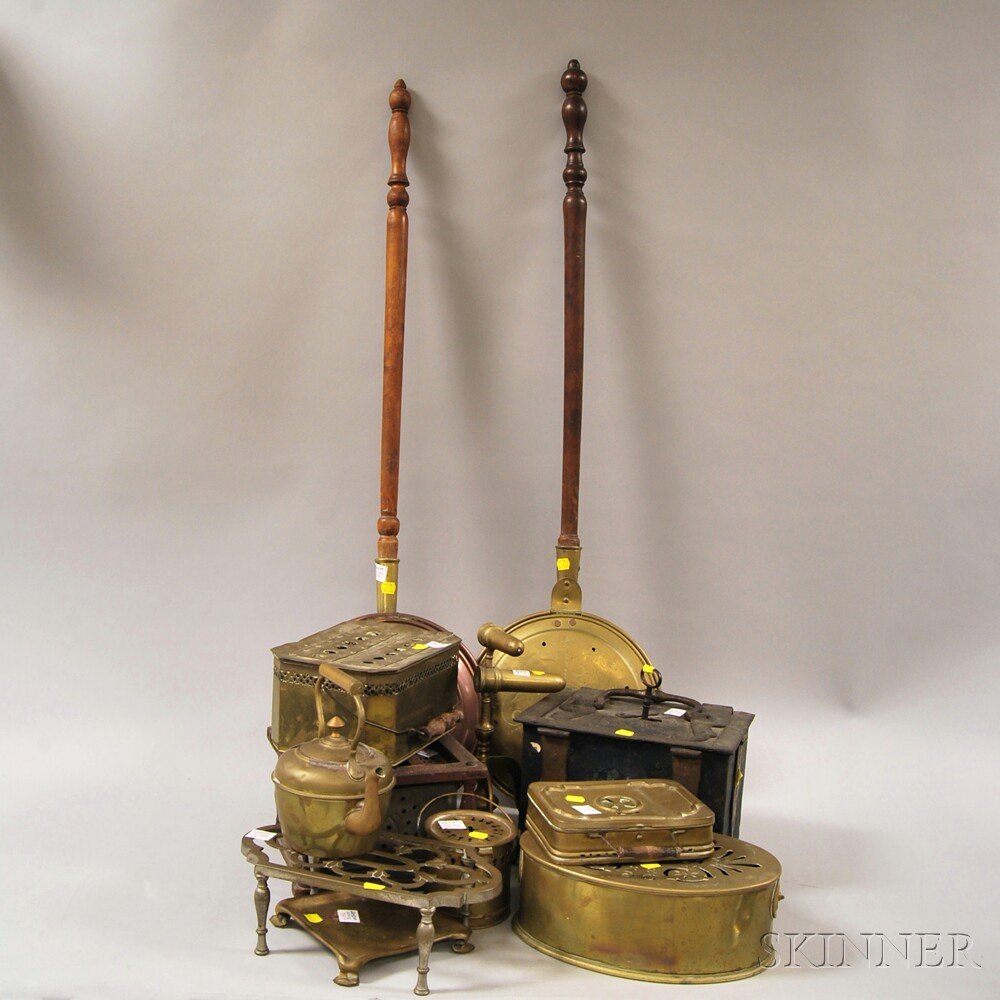 Twelve Assorted Metal Hearth and Domestic Items, includ: Twelve Assorted Metal Hearth and Domestic Items, including a copper bedwarmer with turned wood handle, a tin and wood footwarmer, brass stoker box, hot water kettle, trivet, tinder box, two footwarmer