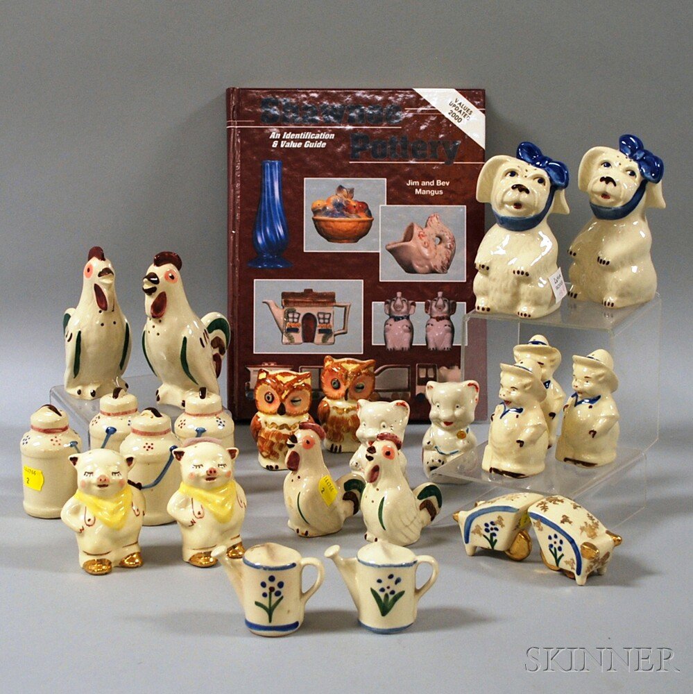 Twenty-three Shawnee Pottery Figural Salt and Pepper Sh: Twenty-three Shawnee Pottery Figural Salt and Pepper Shakers and a Collector's Book, including four chanticleer, three hayseed farmer pigs, two watering cans, two wheelbarrows, two winking owls, two "