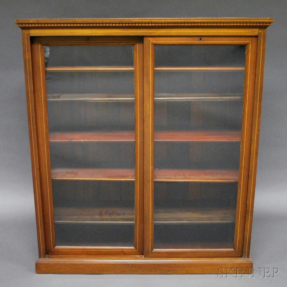 Glazed Two-door Mahogany and Mahogany Veneer Bookcase,: Glazed Two-door Mahogany and Mahogany Veneer Bookcase, with dentil-molded cornice, two sliding doors, and five adjustable shelves, ht. 54, wd. 48, dp. 16 in.