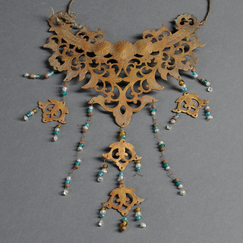 Gilt Copper Necklace, Japan, 20th century, openwork: Gilt Copper Necklace, Japan, 20th century, openwork metal plate with seven strings of beads, chased with Buddhist motifs of flowers and scrolls, lg. 10 in.