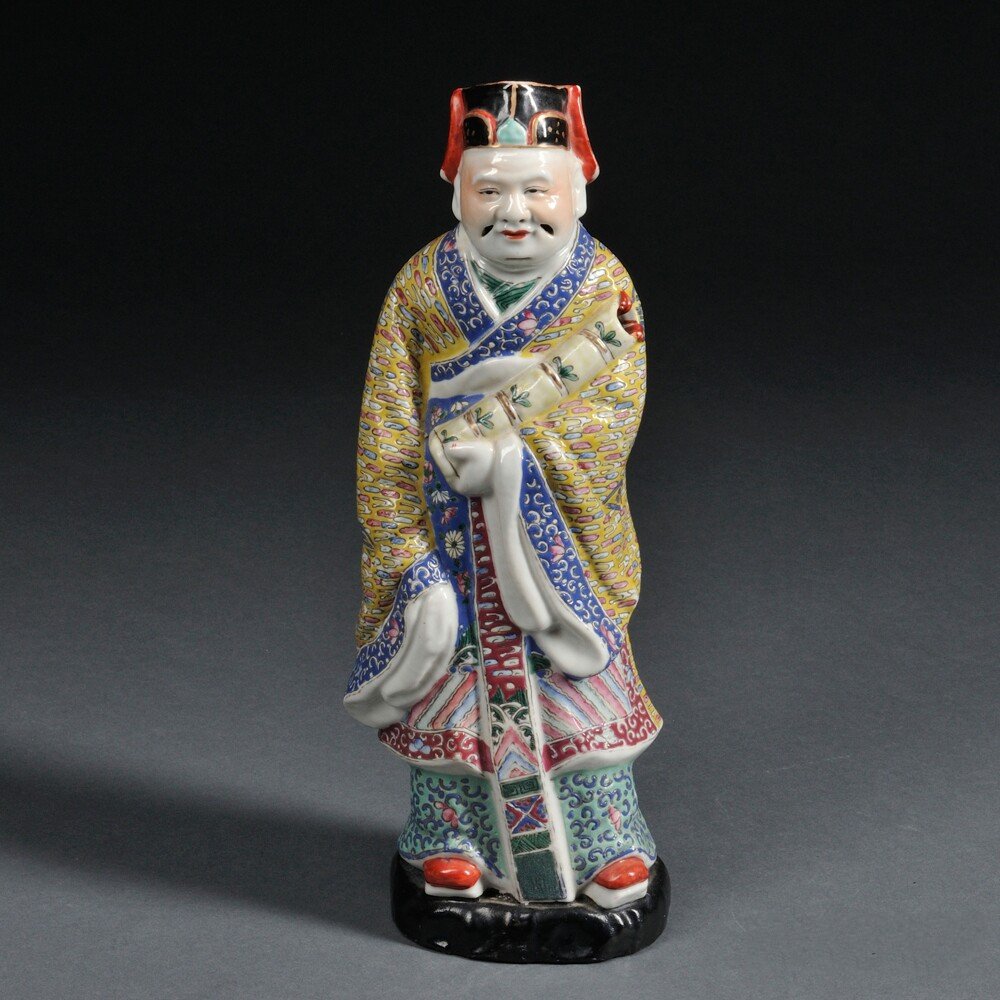 Famille Rose Figure of an Official, China, depicted: Famille Rose Figure of an Official, China, depicted standing with a bamboo section cradled in his left arm, mounted on wood base, ht. 13 in.