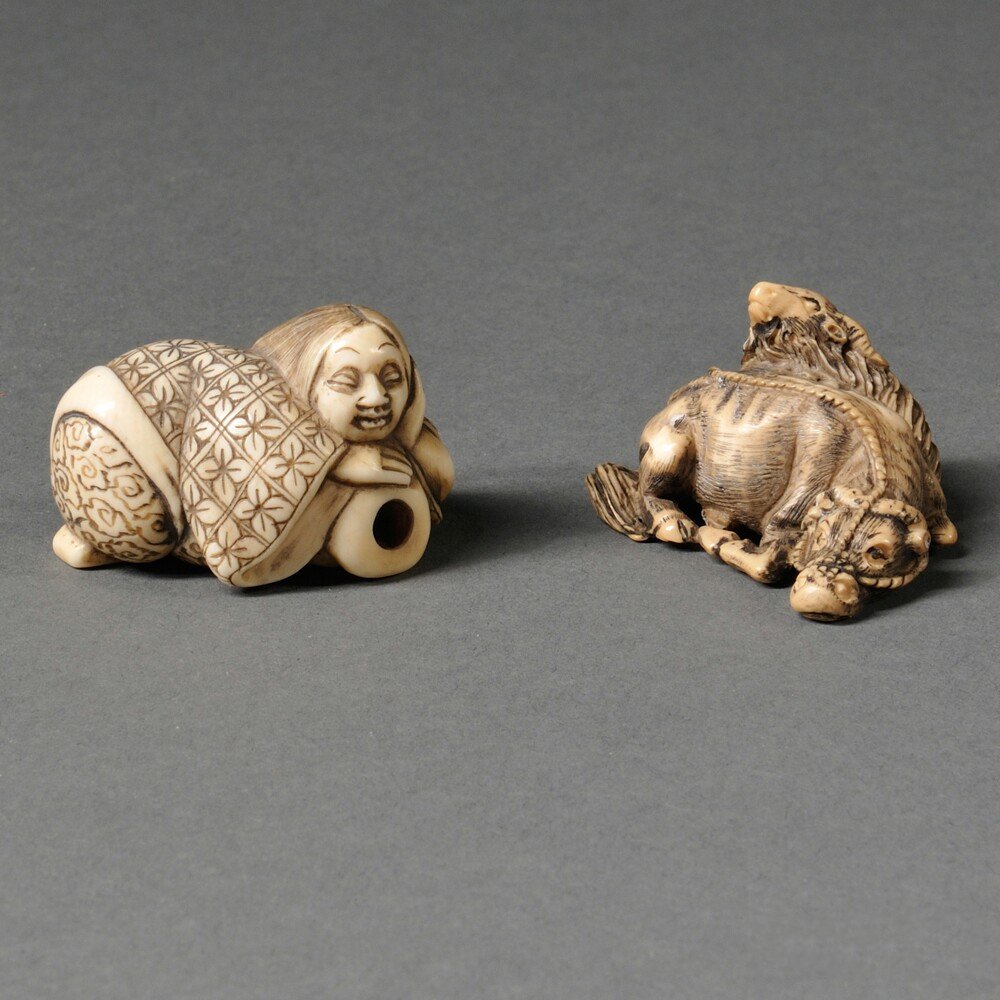 Two Ivory Netsukes, Japan, 20th century, a reclining: Two Ivory Netsukes, Japan, 20th century, a reclining female and a recumbent ox, lg. to 1 7/8 in.