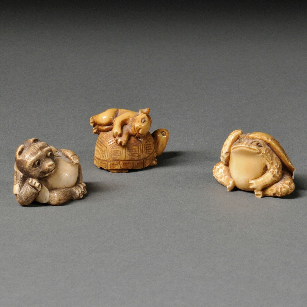 Three Netsukes, Japan, 20th century, a tanuki, a frog,: Three Netsukes, Japan, 20th century, a tanuki, a frog, and a turtle, ht. to 1 1/8 in.