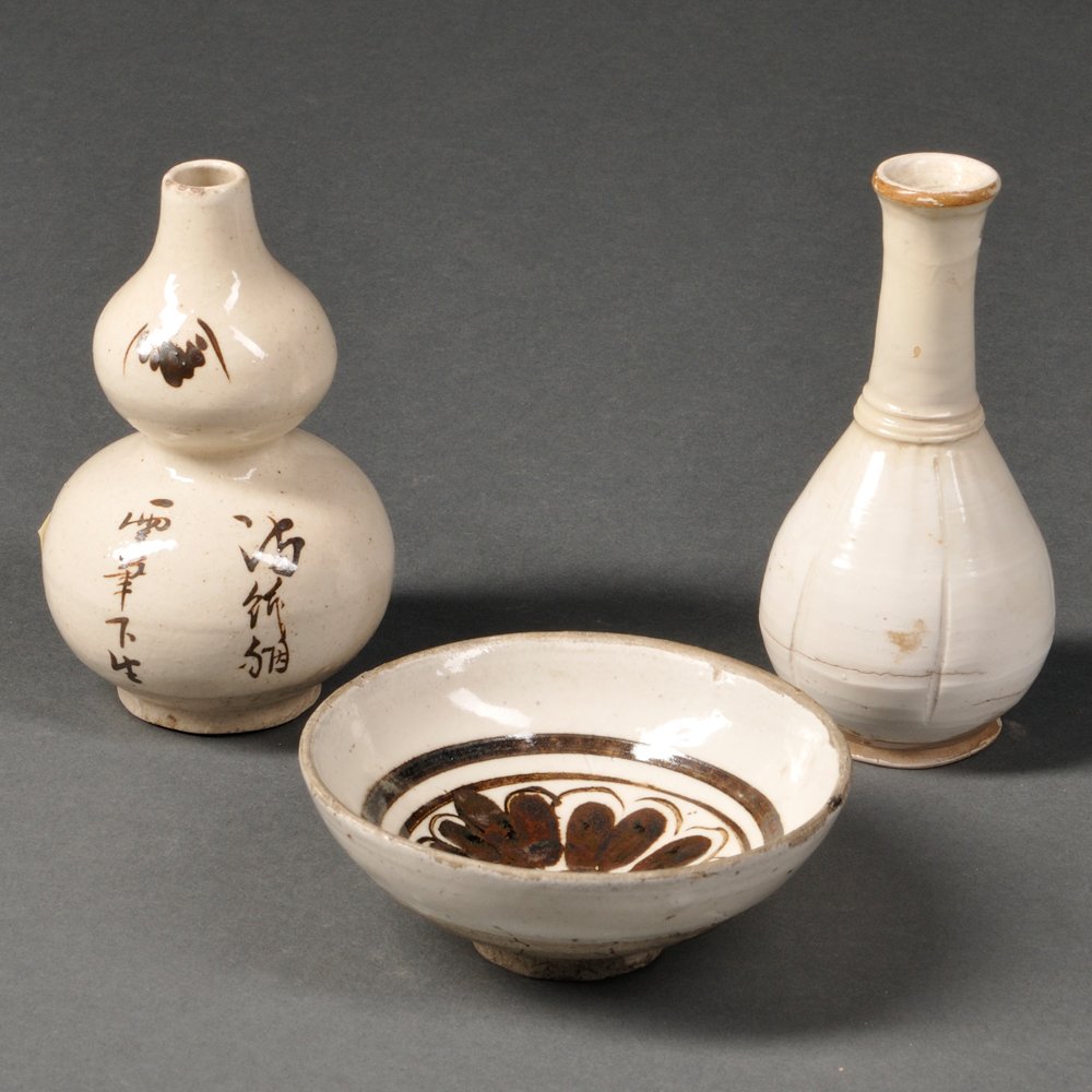 Three Cizhou Wares, China, Song Dynasty style, a small: Three Cizhou Wares, China, Song Dynasty style, a small white glazed bowl with brown decorations, a flower circled by two rings, mouth rim and base unglazed; a small pear-shaped bottle, lobed body and 