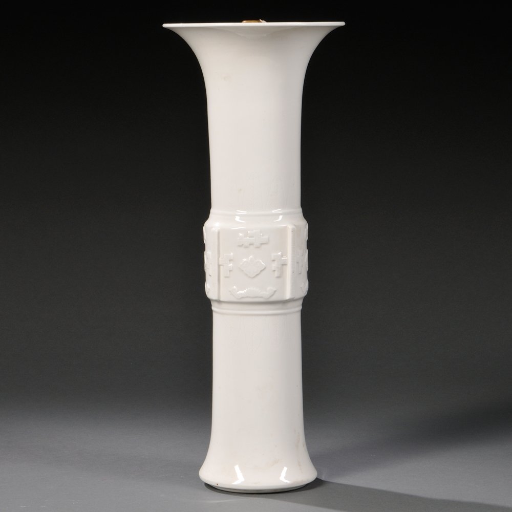 Blanc-de-Chine Beaker Vase, China, 19th/20th century,: Blanc-de-Chine Beaker Vase, China, 19th/20th century, tall body with band of geometric decorations at the middle flanked by incised leaf motifs, bottom drilled, (brass cap glued to the top), ht. 19 in