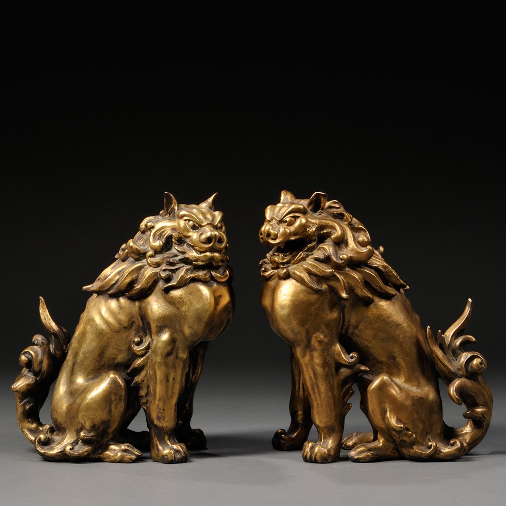 Pair of Gilt-bronze Komainu, Japan, 19th/20th century,: Pair of Gilt-bronze Komainu, Japan, 19th/20th century, seated with their forelegs raised, an a-gyo with its mouth open and an un-gyo with closed mouth, impressed marks to base