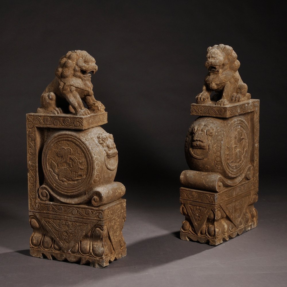 Pair of Door Drums with Buddhist Lions, China,: Pair of Door Drums with Buddhist Lions, China, 18th/19th century, fine-grained granite with inclusions, a rectangular base supports a "drum," the "heads" carved to depict dragons and deer, the frames 