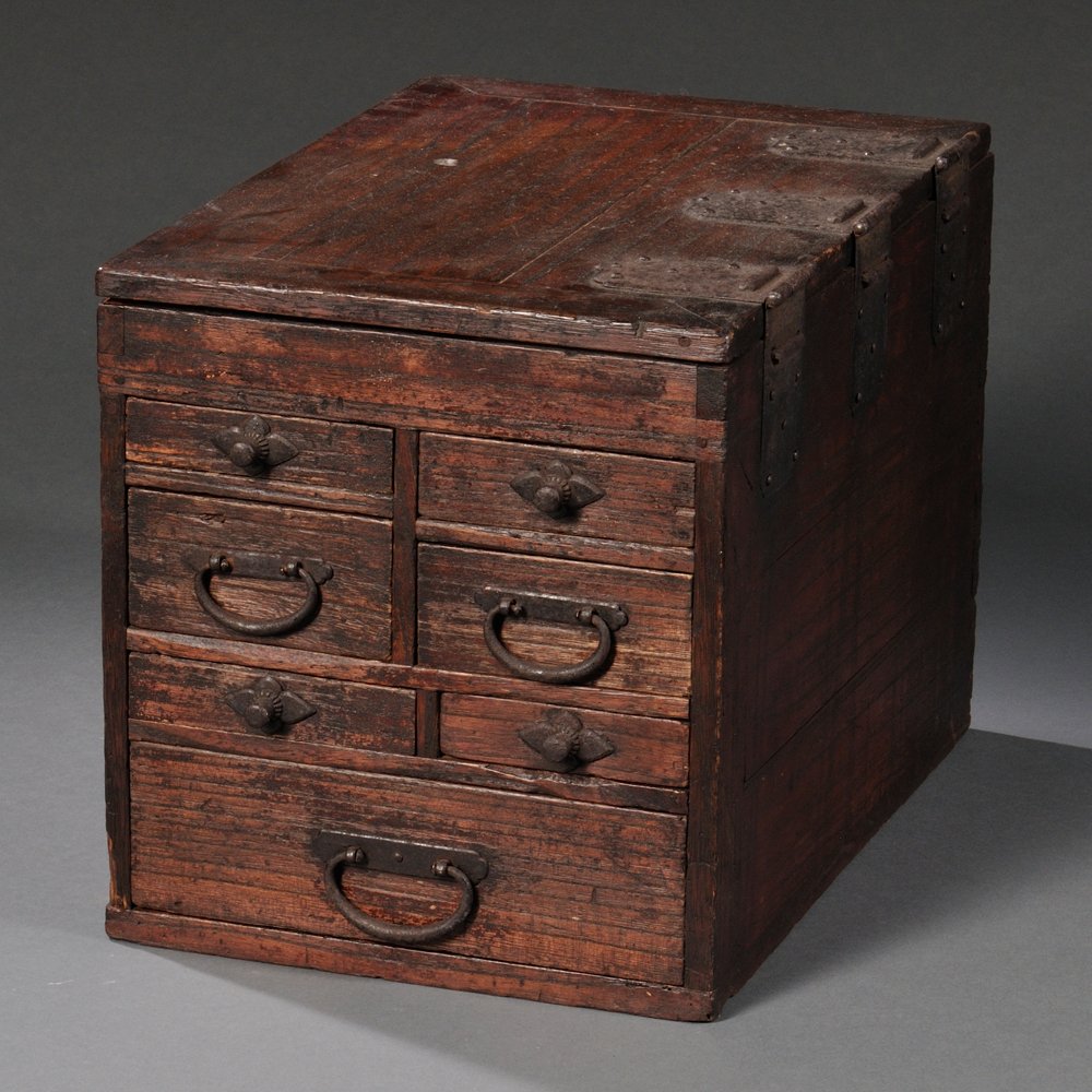 Tabletop Accounts Box, Japan, zelkova, hinged top opens: Tabletop Accounts Box, Japan, zelkova, hinged top opens to compartment for inkstone and water pot (lacking), below seven small drawers, iron hardware, lg. 13 3/4, wd. 9 1/2, ht. 10 1/4 in.