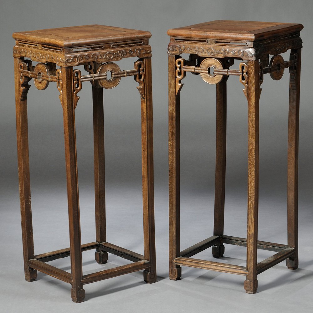 Pair of Jichimu Stands, China, top panel set in curved: Pair of Jichimu Stands, China, top panel set in curved edge frames, carvings of vines on aprons, openwork panels with coin motif, base stretchers, beaded legs ending in incised scrolls, 13 1/2 x 13 1/