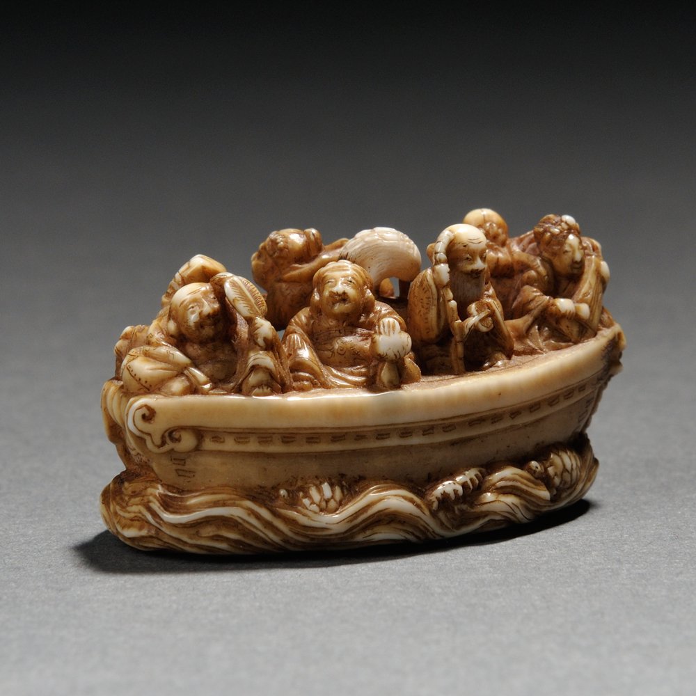 Ivory Netsuke of Seven Lucky Gods, Japan, 19th century,: Ivory Netsuke of Seven Lucky Gods, Japan, 19th century, riding on the Takarabune treasure ship along with a crane, signed "Masatoshi" to base, stained, ht. 3/4, wd. 1 1/2 in.