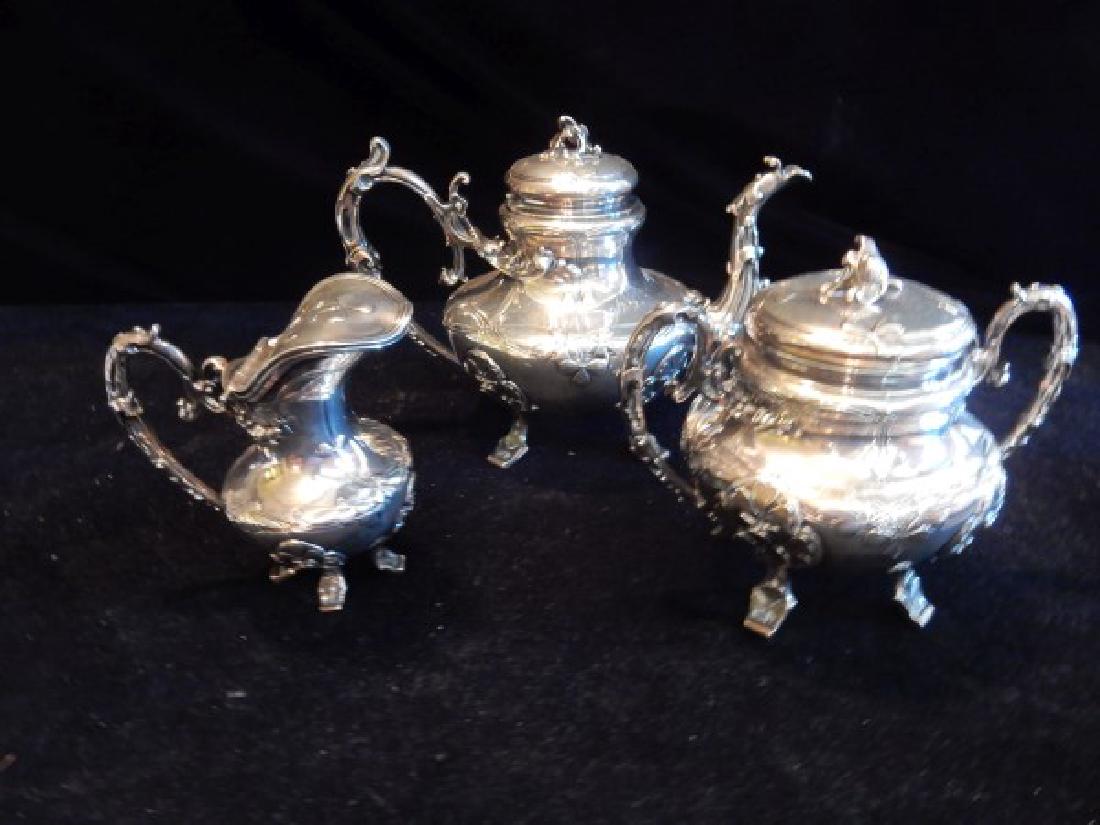 Sterling: French sterling 3 piece tea set by Alphonse Debain, Paris, with applied scrolling design of clover, coffee 6 1/2" h. (teapot 23.59 oz., 669 g., sugar bowl 17.21 oz., 488 g., creamer 9.17 oz., 260 g.),