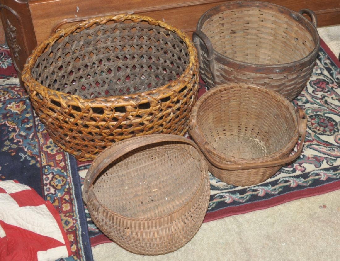 Baskets: 4 antique & vinage baskets: large primitive market basket 2'10" d x 1' h, 2 handle garden basket 1'7" d x 1'1" h, 2 small baskets with handles 1'2" d x 8" h, late 19th/early 20th century