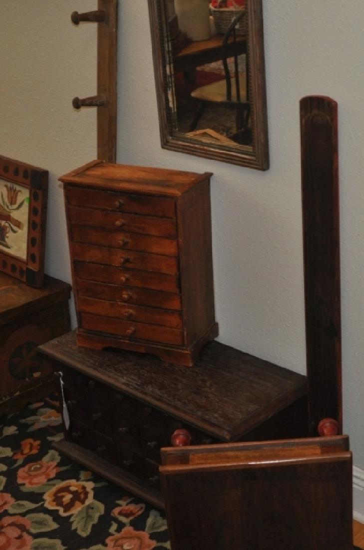 Furniture: Stool with red painted legs 15" square x 6" h, old wood framed mirror 13" w x 19" h, spice chest with 8 drawers 1' w x 7" d x 1'5" h, 8 peg coat rack 4', long candle/fruit tray 3'4", 20th century