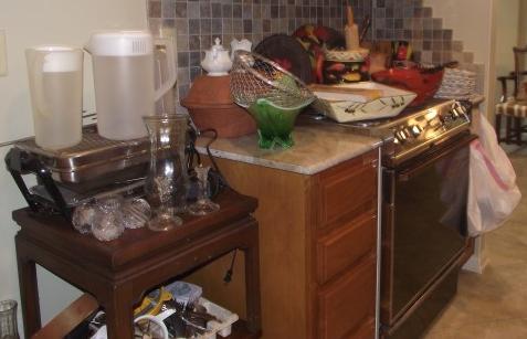 Kitchen: Large assortment of kitchen & serving items & 3 wood Oriental style tables: artichoke dishes, pottery, painted glass dishes, pitcher, bowls, metal basket, Faberware grill, Pyrex, flatware & misc.