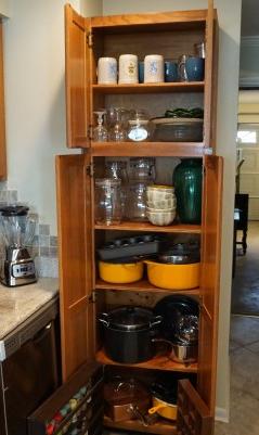 Kitchen: Kitchen items: 3 LE CRUET Dutch ovens, 2 with lids, wine glasses, baking items, spice racks, etc.
