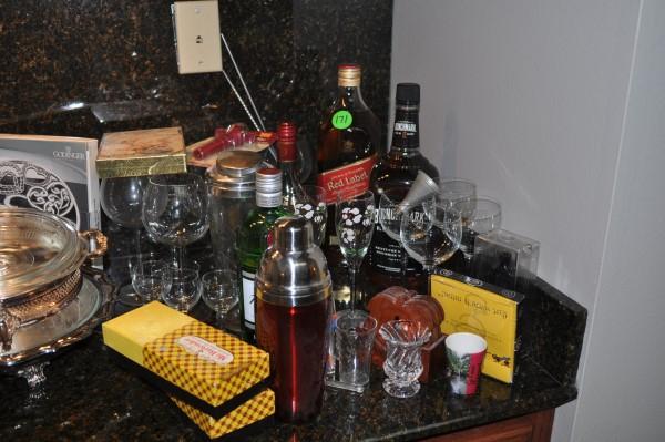 Large assortment of bar ware: Large assortment of bar ware: 1960's cocktail glasses-7 high ball glasses, 8 double old fashion glasses, wine glasses, alcohol bottles, 2 martini shakers, coasters, wine openers, stainless drink stirr