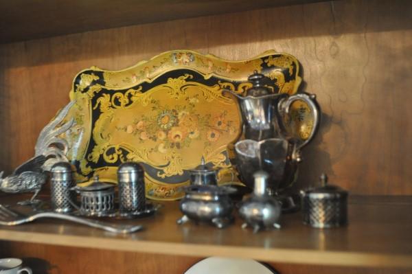 Vintage paper mache tray with silver plate: Vintage paper mache tray, silver plate creamer, 2 salt cellars with cobalt blue liners, small bottle, pair of pewter roosters, serving fork, 20th century