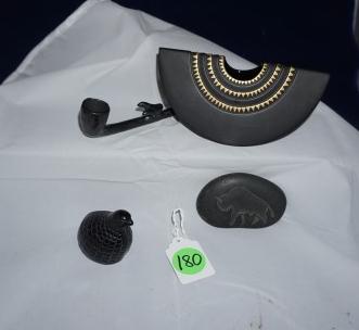4 black pottery and stone:: 4 black pottery and stone: Black porcelain vase by Rosenthal, Germany, artist signed, black river rock with carving of buffalo, small black pipe, small black bird, 20th century