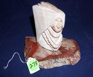 Red Alabaster head with headdress by Victor Vigil: Red Alabaster head with headdress by Victor Vigil "Painted Warrior" 5" h, displayed on a stone base, 20th century