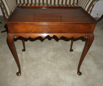 Mahogany butler style table, 2 pull out shelves on: Mahogany butler style table, 2 pull out shelves on sides, carved apron, Queen Anne feet 29 1/2" w x 18" d x 26" h, 20th century