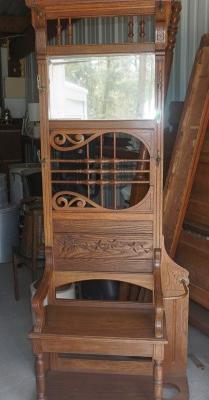 English oak hall tree with beveled mirror, 6 brass: English oak hall tree with beveled mirror, 6 brass hooks, seat, umbrella stand 30" w x 14" d x 79" h, 19th century