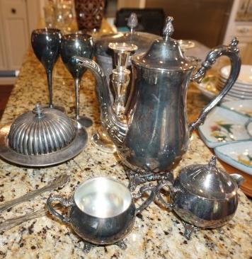 Assortment of silver plate: tea pot, creamer & sugar,: Assortment of silver plate: tea pot, creamer & sugar, pair of candle sticks, covered ice bucket, pair of goblets, covered butter dish, tongs, 20th & 21st century