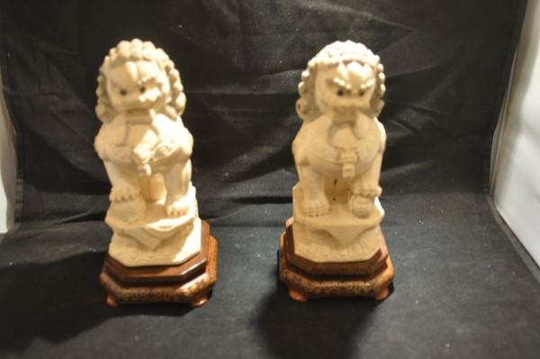 Pair of hand painted & hand carved bone foo dogs on: Pair of hand painted & hand carved bone foo dogs on wood base 8" h (with base), early 20th century
