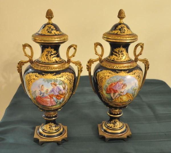 Meissen Porcelain: Pair of hand painted porcelain covered urns by Meissen, brass handles & finals 19" h,, 20th century