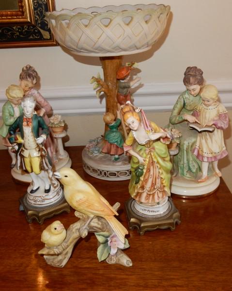 Porcelains: Assortment of bisque and porcelain: large ornate bisque center compote, pair of bisque figurines, Lefton birds, pair of Continental porcelain statues, 20th century