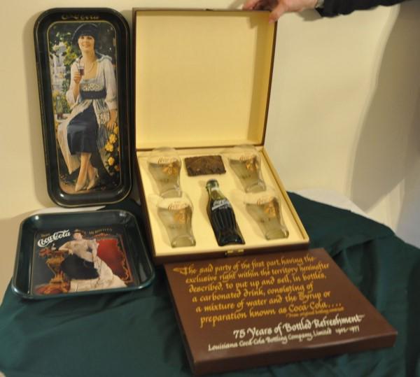 Coca Cola Collectibles: Coca Cola 75 years memorabilia: 4 glasses, bottle of coke & brass buckle in box, tray in box, tray without box, 20th century