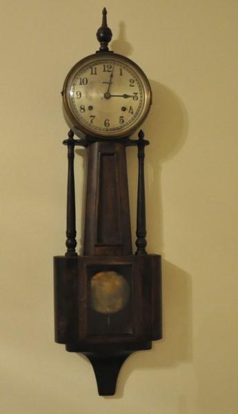 Antique Wall Clock: Antique wall clock, glass door on base by Ingraman 10" x 36", 19th century