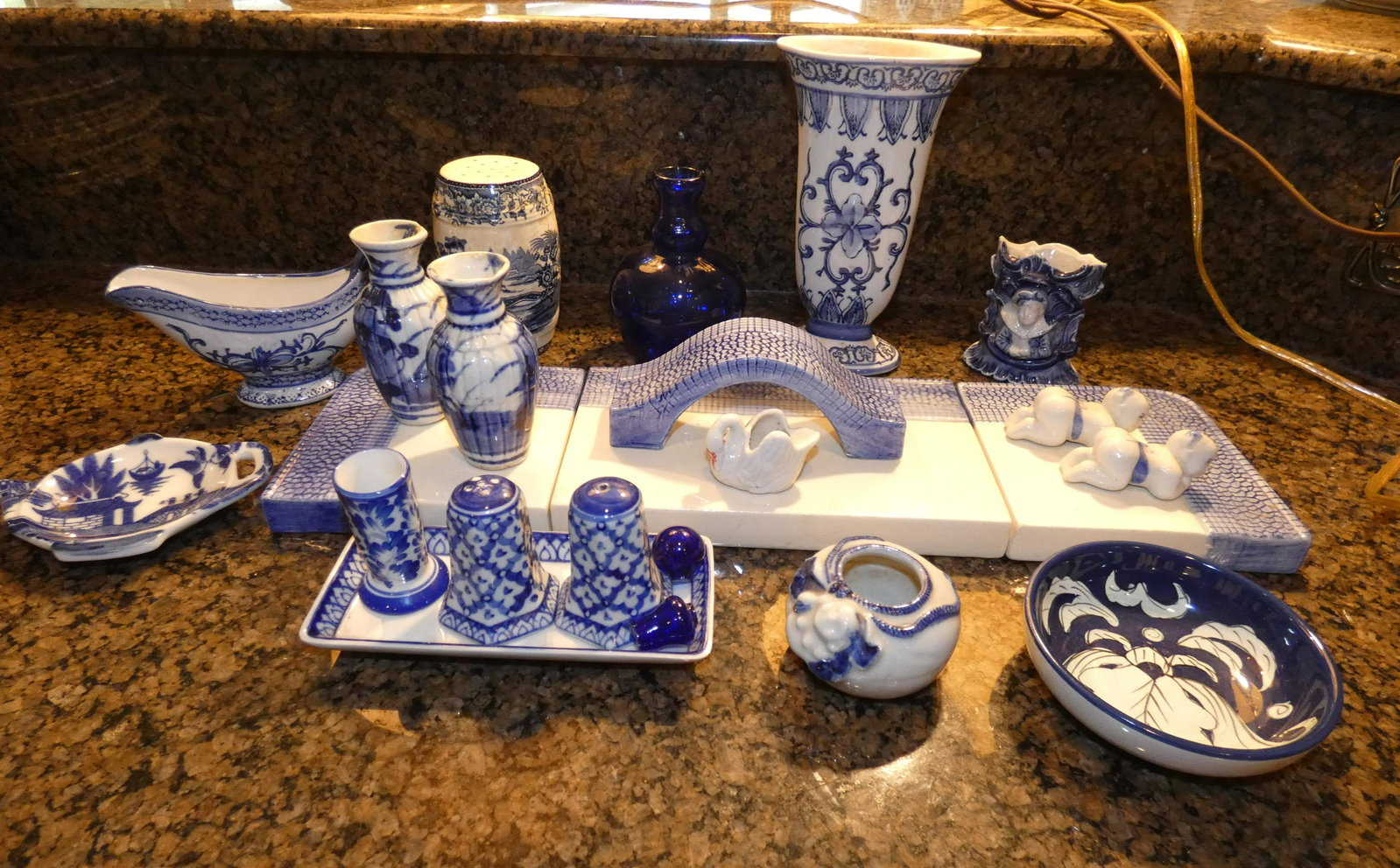Blue & white porcelain & collectibles: Blue & white porcelain & collectible:5 vases, bowl, gravy boat, tea bag holder, salt & pepper, toothpick holder on tray, Asian baby knife rest, swan from Japan, porcelain bridge, 20th & 21st century