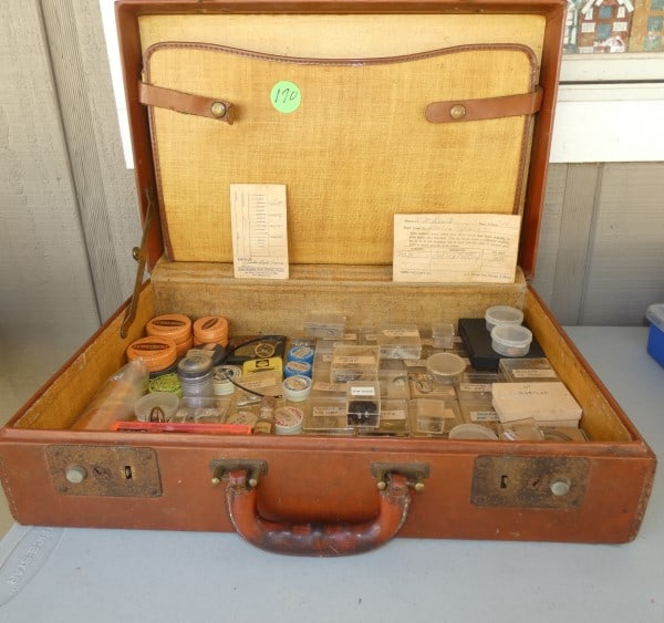 Vintage leather briefcase with watch faces: Vintage leather briefcase with watch faces, vintage & antique tins with watch repair parts, early to mid 20th century