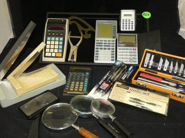 Vintage office supplies: Vintage office supplies: 5 calculators-3nTexas Instruments & 1 Unisonic, paper trimmers, Exacto Knife in box, Italic pen set in box, 4 magnifying glasses, hole puncher, mid 20th century
