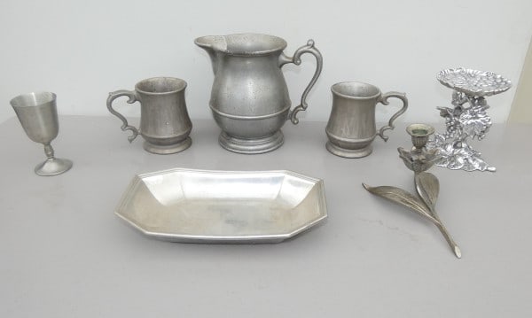 Collection of pewter: Collection of pewter: Pewter pitcher with 2 mugs, wine cup, bread dish, flower candlestick, candle holder, 20th century
