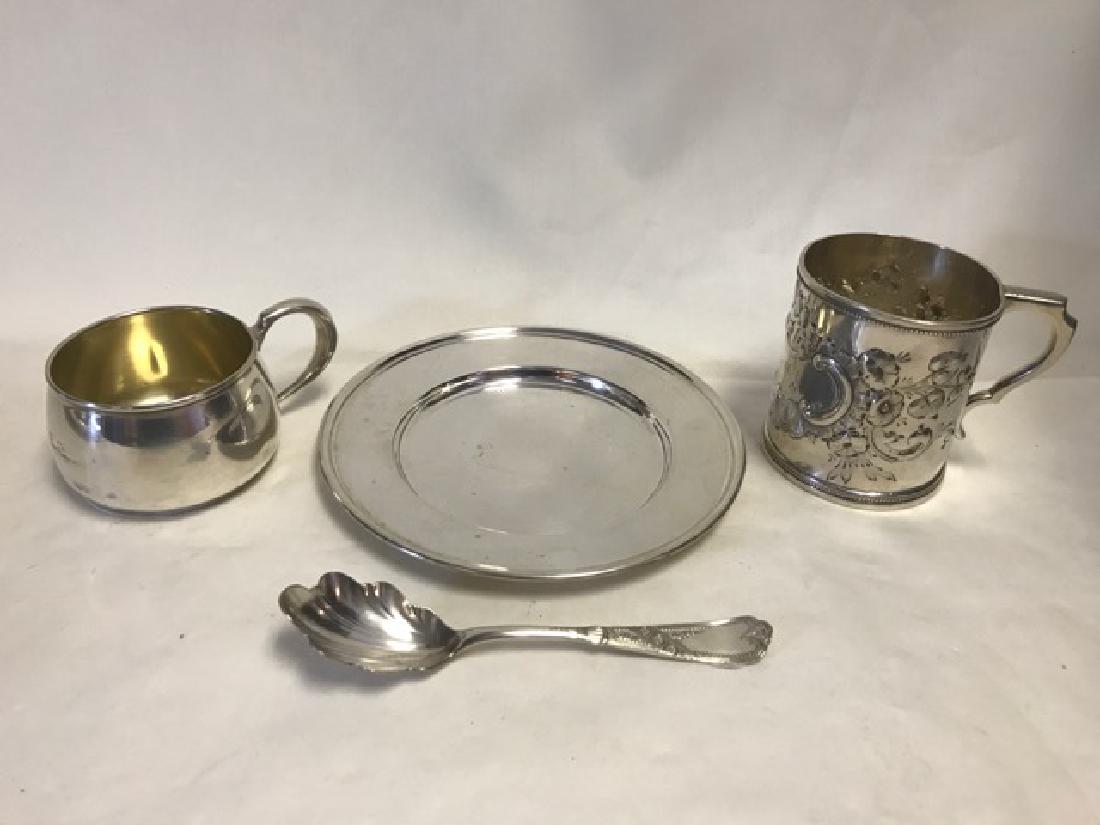 Sterling Silver Lot: To include a sterling bread plate; a sterling baby cup (as-is dented); a coin silver embossed mug marked WG&S (William Gale & Sons - 1853-1866); and a silver plated Rogers & Bro. A1 sugar spoon. 6-1/2