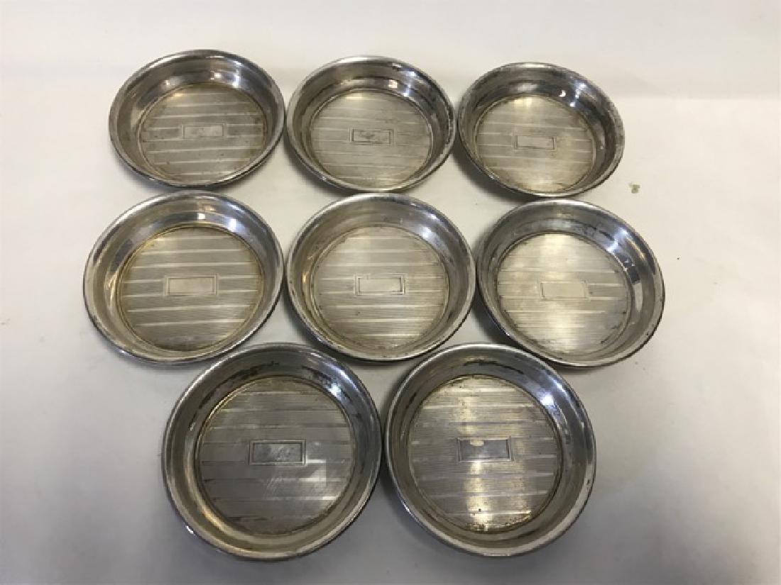 Sterling Silver Coasters (8): Small sterling silver coasters, with rectangular space for a monogram, marked Sterling. 154.1 grams. 2-1/2" diameter; 153.9 grams