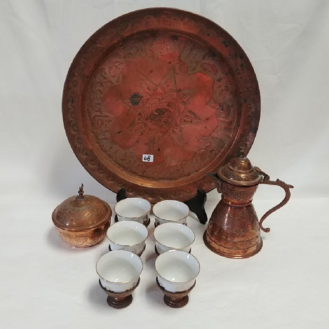 Copper Turkish Coffee Service: Copper tray, coffee pot, sugar bowl and six cups with porcelain liners. Decorated with Turkish designs. 12-3/4" diameter the tray