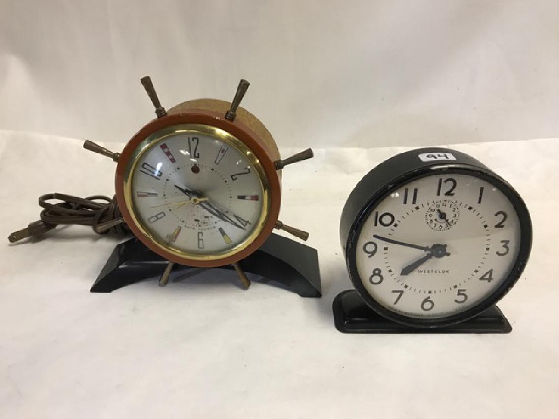 Two Vintage Clocks - Westclox and Seth Thomas: Black painted Westclox (non working) together with a nautical themed electric clock Model No. E925-003. 4-1/2" high; 4-1/2" high