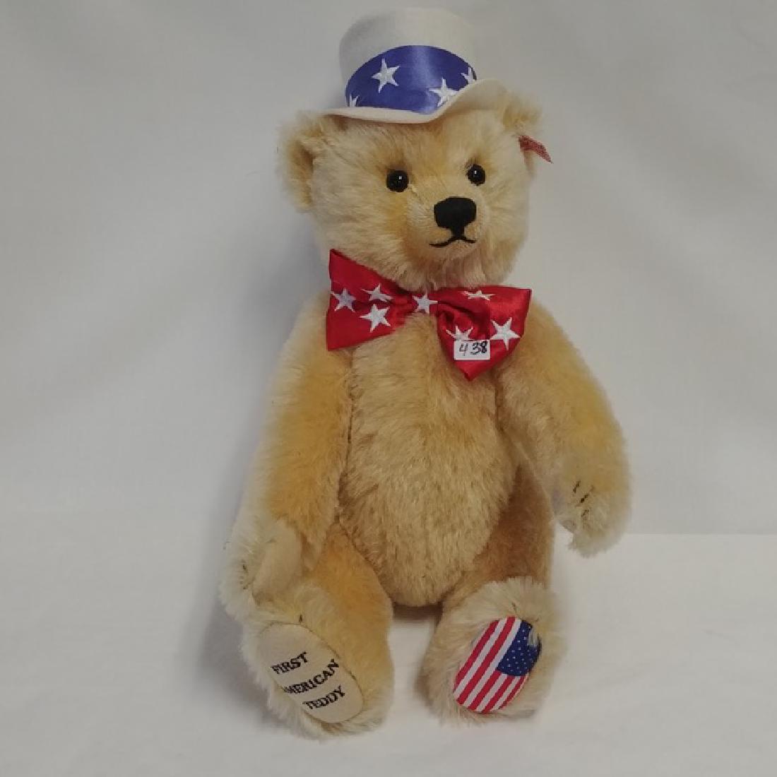 Steiff First Amerian Teddy Bear: Wearing top hat and red starred bow tie. American Flag on foot. He is a growler. Red and white striped tag in ear. 16" high