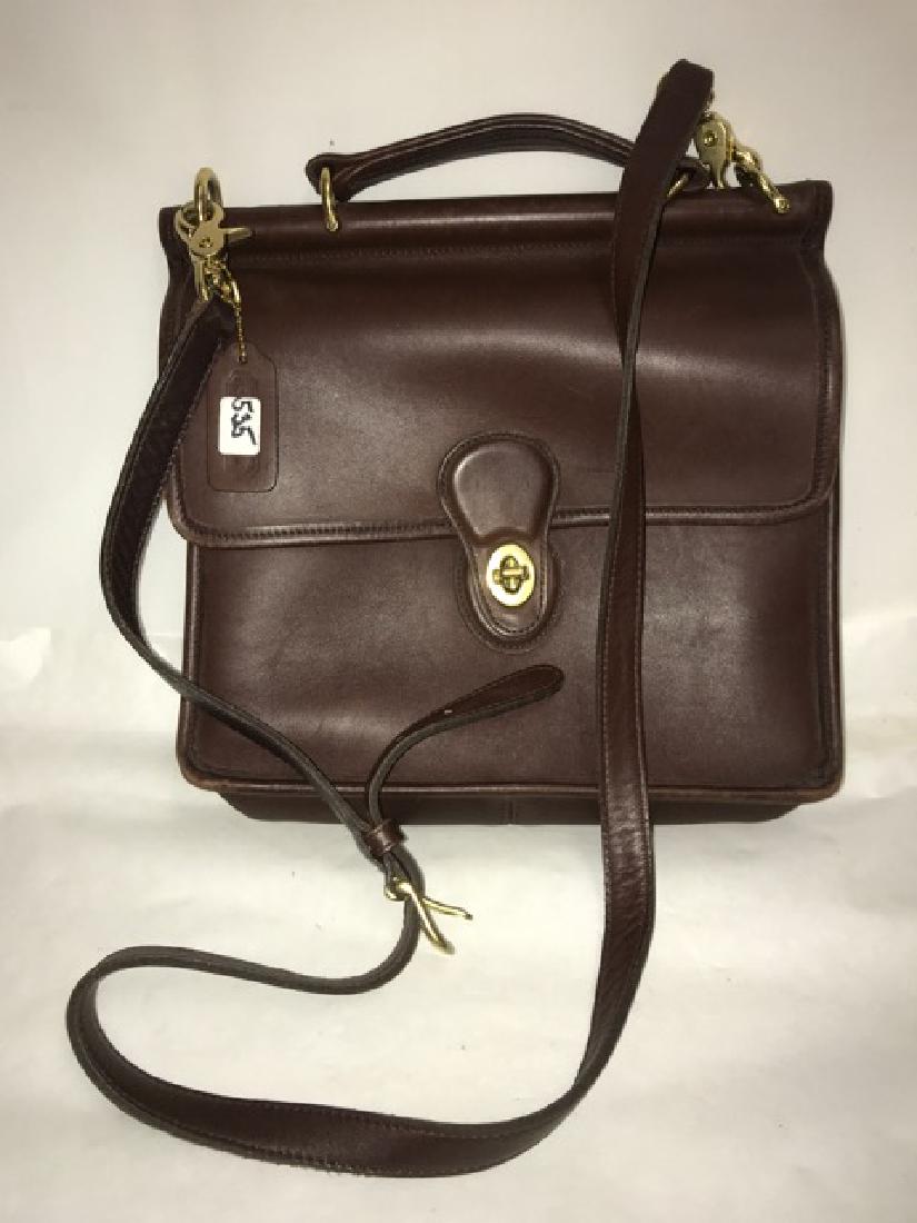 Leather Coach Handbag: Brown leather shoulder saddle bag style purse with toggle closure and leather handle. 10-1/2" across