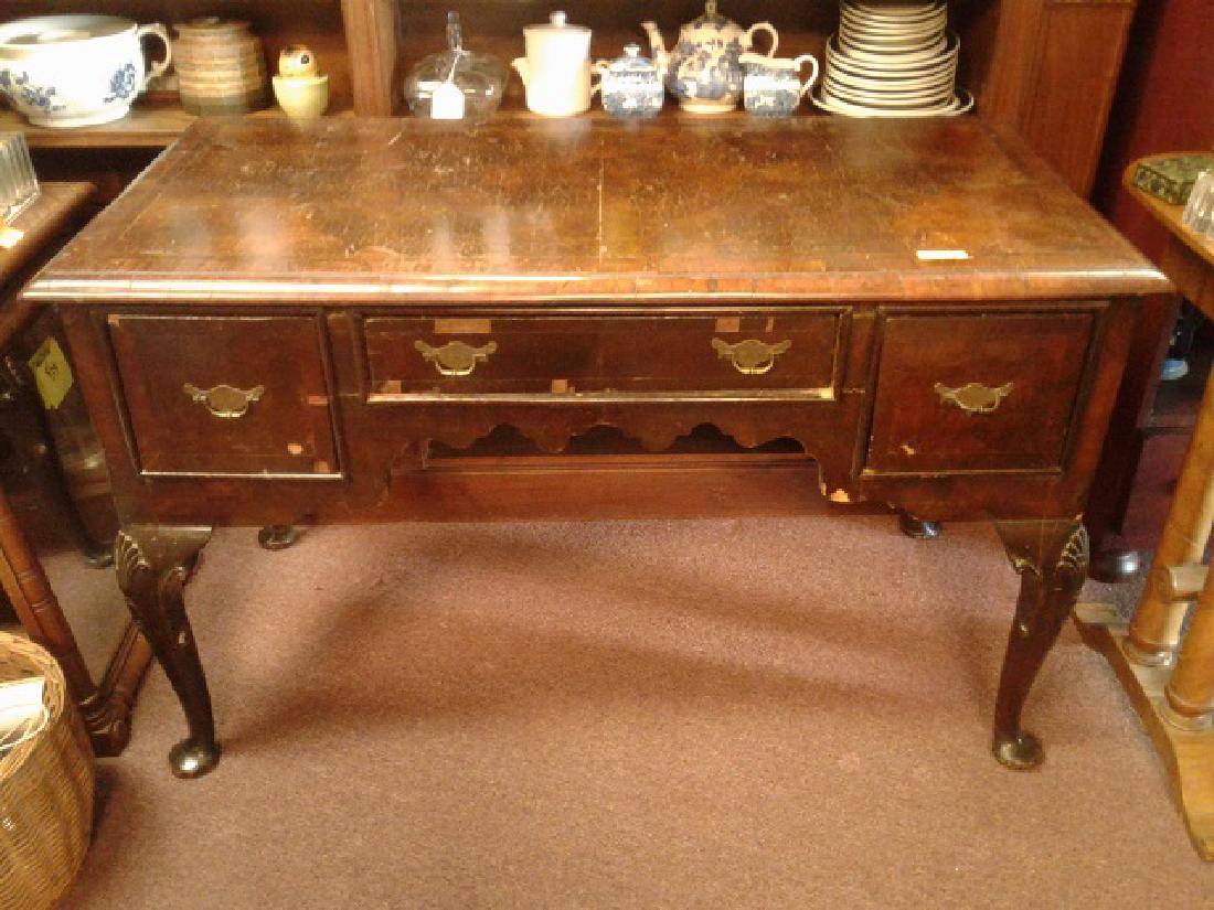 19th C. Queen Anne Desk: Three drawer. William & Mary brass bail handles. Veneer repairs and losses. 47" x 23" x 30" h